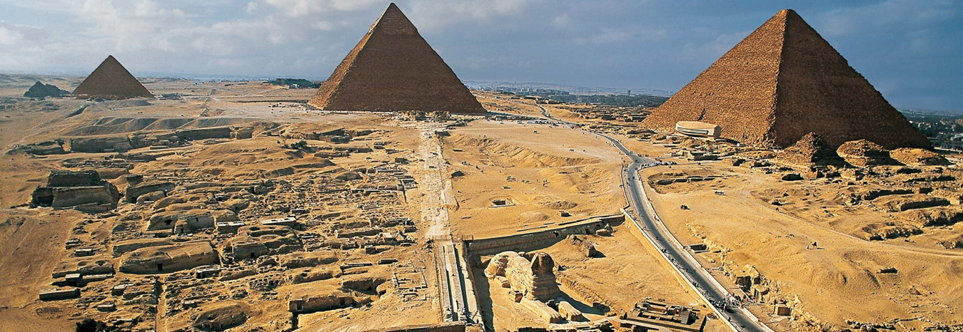 The Great Pyramids of Giza and the Great Sphinx under a blue sky - Cairo Egypt